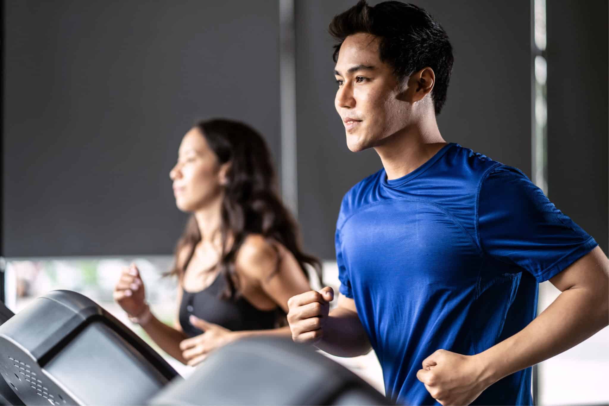 Man and woman jogging on treadmill