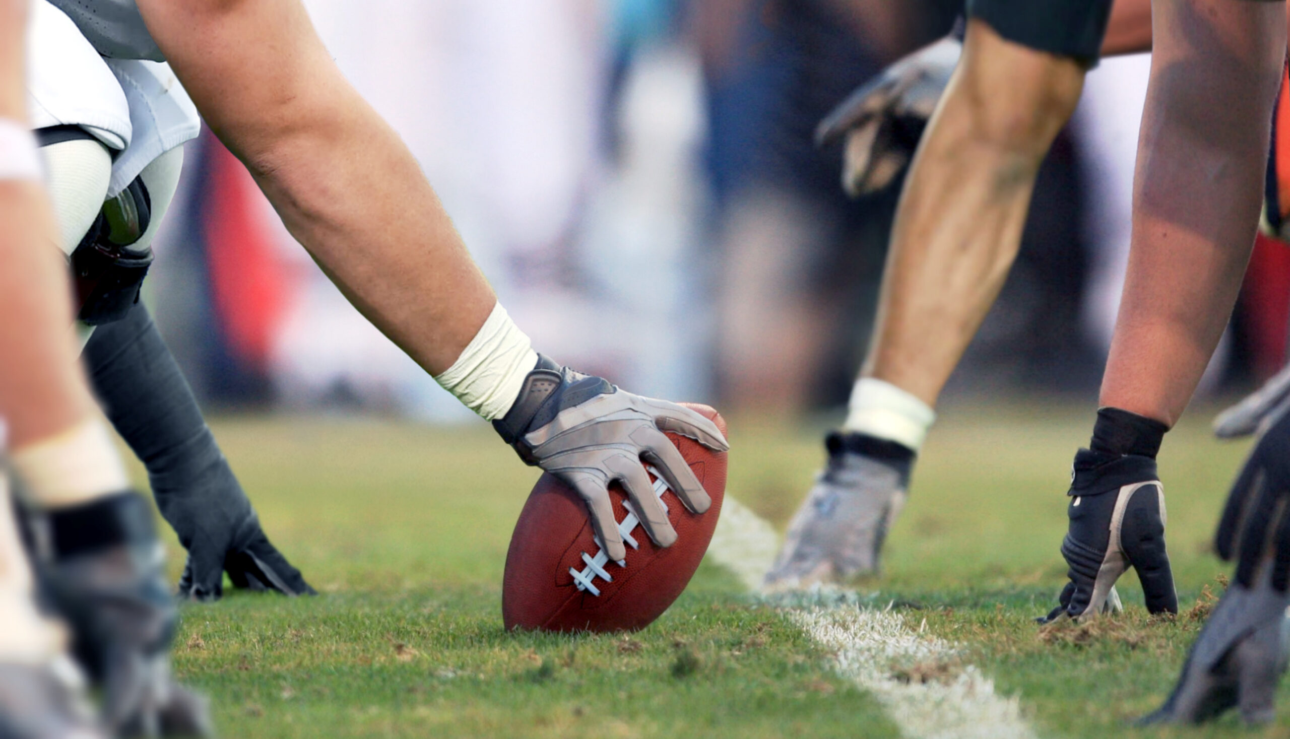 The Best Game Day Spots Near UNCC for Niner Football 1 Charlotte 49ers football fans watching a game on a large screen at a modern off-campus apartment.